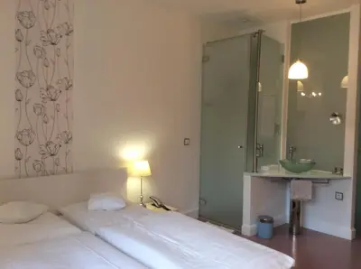 Ein Bett oder Betten in einem Zimmer der Unterkunft Hotel Heidelberg Astoria