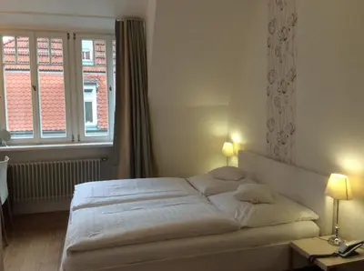 Ein Bett oder Betten in einem Zimmer der Unterkunft Hotel Heidelberg Astoria