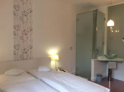 Ein Bett oder Betten in einem Zimmer der Unterkunft Hotel Heidelberg Astoria