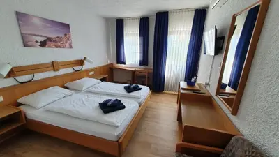 Ein Bett oder Betten in einem Zimmer der Unterkunft Prestige Bistro & Pension