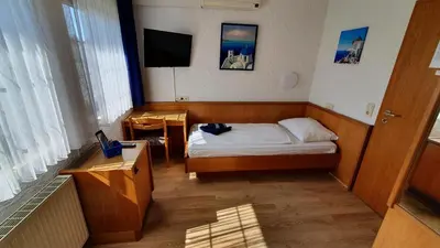 Ein Bett oder Betten in einem Zimmer der Unterkunft Prestige Bistro & Pension