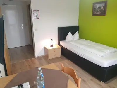 Ein Bett oder Betten in einem Zimmer der Unterkunft Hotel Arheilger Hof