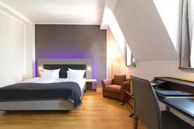 Ein Bett oder Betten in einem Zimmer der Unterkunft Qube Hotel Bergheim
