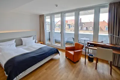 Ein Bett oder Betten in einem Zimmer der Unterkunft Qube Hotel Bergheim