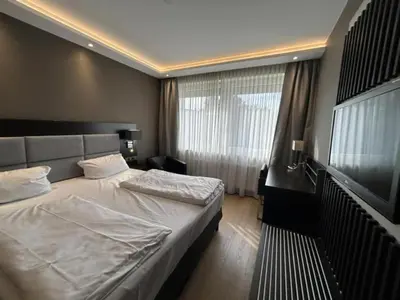 Ein Bett oder Betten in einem Zimmer der Unterkunft Zi Hotel