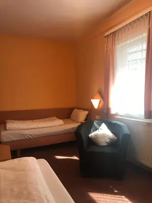 Ein Bett oder Betten in einem Zimmer der Unterkunft Poseidon Hotel