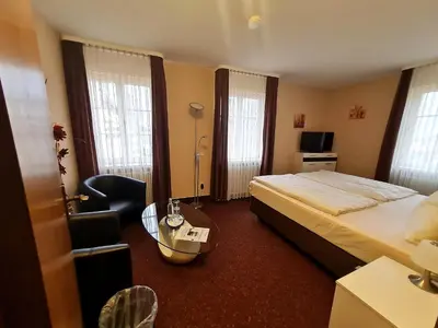 Ein Bett oder Betten in einem Zimmer der Unterkunft Hotel Am Schloss