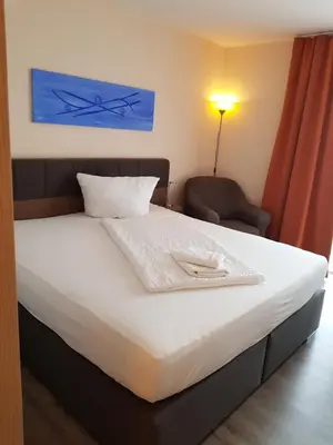 Ein Bett oder Betten in einem Zimmer der Unterkunft Hotel Ackermann