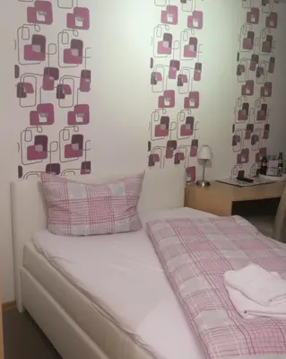 Ein Bett oder Betten in einem Zimmer der Unterkunft Hotel Ackermann