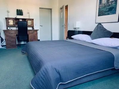 Ein Bett oder Betten in einem Zimmer der Unterkunft Hotel Mainzer Hof