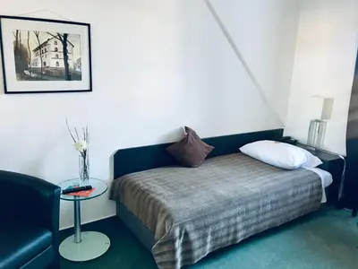 Ein Bett oder Betten in einem Zimmer der Unterkunft Hotel Mainzer Hof