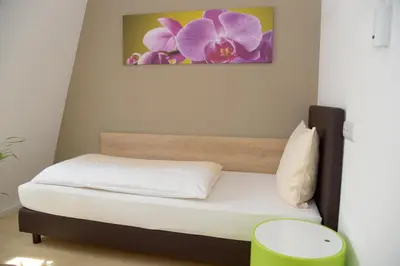 Ein Bett oder Betten in einem Zimmer der Unterkunft Hotel - Restaurant Baumann