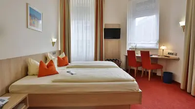 Ein Bett oder Betten in einem Zimmer der Unterkunft City Partner Hotel Berliner Hof