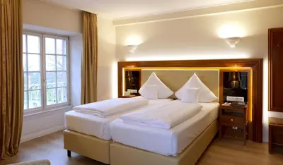 Ein Bett oder Betten in einem Zimmer der Unterkunft Hotel Schloss Edesheim