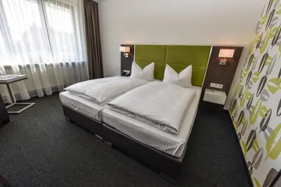 Ein Bett oder Betten in einem Zimmer der Unterkunft Hotel Vorfelder