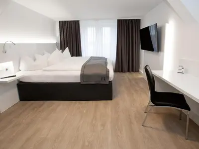 Ein Bett oder Betten in einem Zimmer der Unterkunft DORMERO Hotel Worms