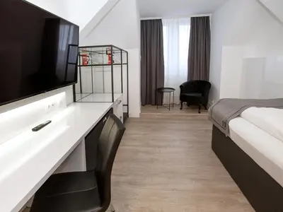 Ein Bett oder Betten in einem Zimmer der Unterkunft DORMERO Hotel Worms