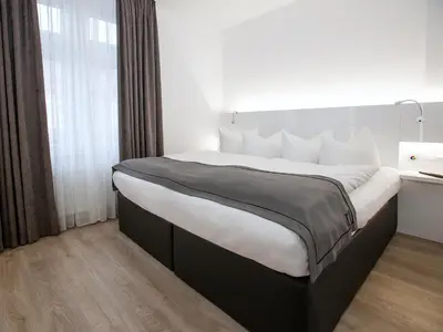 Ein Bett oder Betten in einem Zimmer der Unterkunft DORMERO Hotel Worms