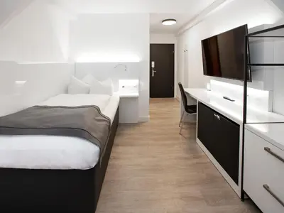 Ein Bett oder Betten in einem Zimmer der Unterkunft DORMERO Hotel Worms