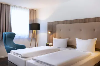 Ein Bett oder Betten in einem Zimmer der Unterkunft ACHAT Hotel Stuttgart Zuffenhausen