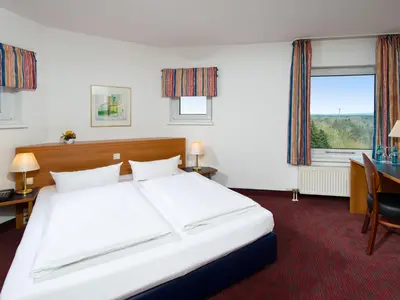 Ein Bett oder Betten in einem Zimmer der Unterkunft ACHAT Hotel Darmstadt Griesheim