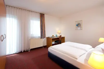 Ein Bett oder Betten in einem Zimmer der Unterkunft ACHAT Hotel Darmstadt Griesheim