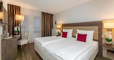 Ein Bett oder Betten in einem Zimmer der Unterkunft PLAZA INN Karlsruhe Nord
