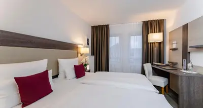 Ein Bett oder Betten in einem Zimmer der Unterkunft PLAZA INN Karlsruhe Nord