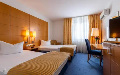 Ein Bett oder Betten in einem Zimmer der Unterkunft Trip Inn Kongresshotel Frankfurt-Rodgau