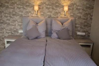 Ein Bett oder Betten in einem Zimmer der Unterkunft Villa Kopp-Das Gästehaus