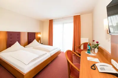 Ein Bett oder Betten in einem Zimmer der Unterkunft Hotel Restaurant Vater Rhein