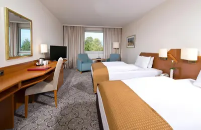 Ein Bett oder Betten in einem Zimmer der Unterkunft Leonardo Hotel Heidelberg