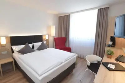 Ein Bett oder Betten in einem Zimmer der Unterkunft Best Western Queens Hotel Pforzheim-Niefern
