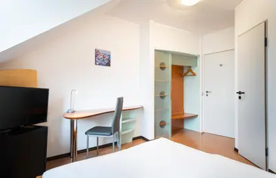 Ein Bett oder Betten in einem Zimmer der Unterkunft Mainstreet Hotel