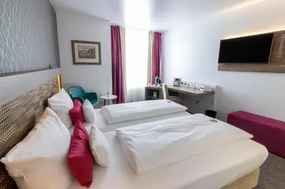 Ein Bett oder Betten in einem Zimmer der Unterkunft Best Western Plus Palatin Kongresshotel