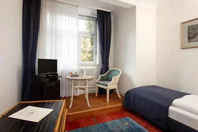 Ein Bett oder Betten in einem Zimmer der Unterkunft Parkhotel Atlantic