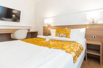 Ein Bett oder Betten in einem Zimmer der Unterkunft Hotel & Living Am Wartturm