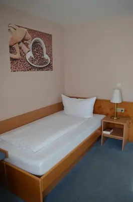 Ein Bett oder Betten in einem Zimmer der Unterkunft Hotel Zum Goldenen Mann