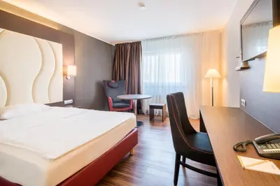 Ein Bett oder Betten in einem Zimmer der Unterkunft Airways Hotels Frankfurt Airport West