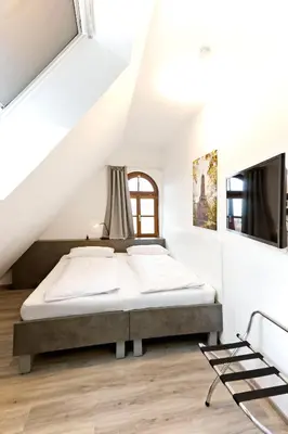 Ein Bett oder Betten in einem Zimmer der Unterkunft Vinotel Weinstrasse