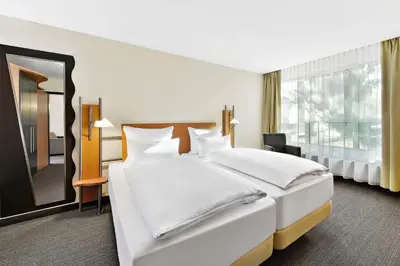 Ein Bett oder Betten in einem Zimmer der Unterkunft NH Mannheim Viernheim