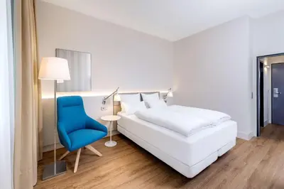 Ein Bett oder Betten in einem Zimmer der Unterkunft NH Weinheim