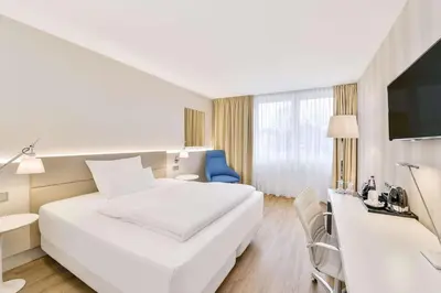 Ein Bett oder Betten in einem Zimmer der Unterkunft NH Weinheim