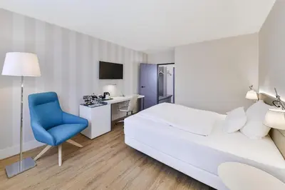 Ein Bett oder Betten in einem Zimmer der Unterkunft NH Weinheim