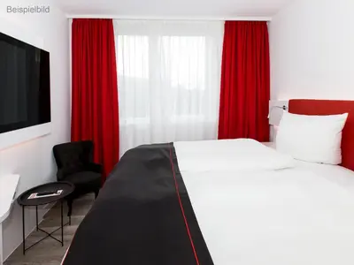 Ein Bett oder Betten in einem Zimmer der Unterkunft DORMERO Hotel Darmstadt