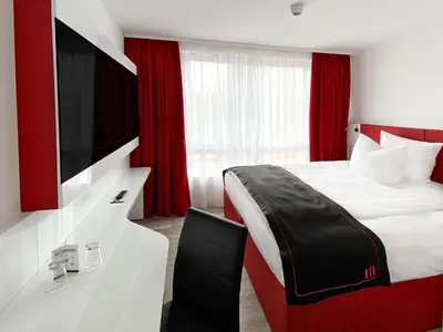 Ein Bett oder Betten in einem Zimmer der Unterkunft DORMERO Hotel Darmstadt