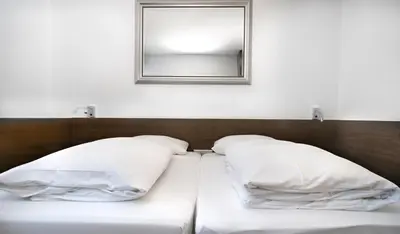 Ein Bett oder Betten in einem Zimmer der Unterkunft Stadthotel Heilbronn