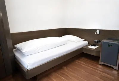 Ein Bett oder Betten in einem Zimmer der Unterkunft Stadthotel Heilbronn