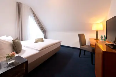 Ein Bett oder Betten in einem Zimmer der Unterkunft ACHAT Hotel Neustadt an der Weinstraße