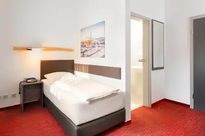 Ein Bett oder Betten in einem Zimmer der Unterkunft Hotel Speyer am Technik Museum